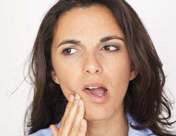 Woman touching cheek because of tooth pain