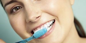 Woman brushing teeth for oral health