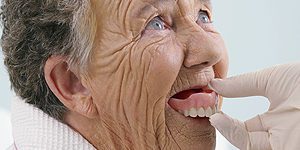 Elderly Woman Trying on Dentures