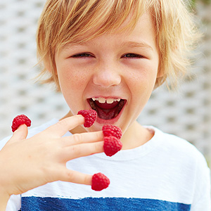 Kid with Raspberry in his fingers