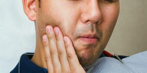 Man Touching Cheek Due to Tootache
