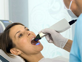 Dental patient undergoing dental exam using scanning wand