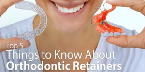 Person holding orthodontic retainers