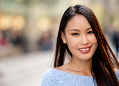 Portrait of a beautiful Asian woman on the street looking at the camera smiling